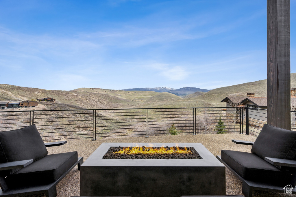 View of patio featuring a mountain view, fence private yard, and an outdoor living space with a fire pit
