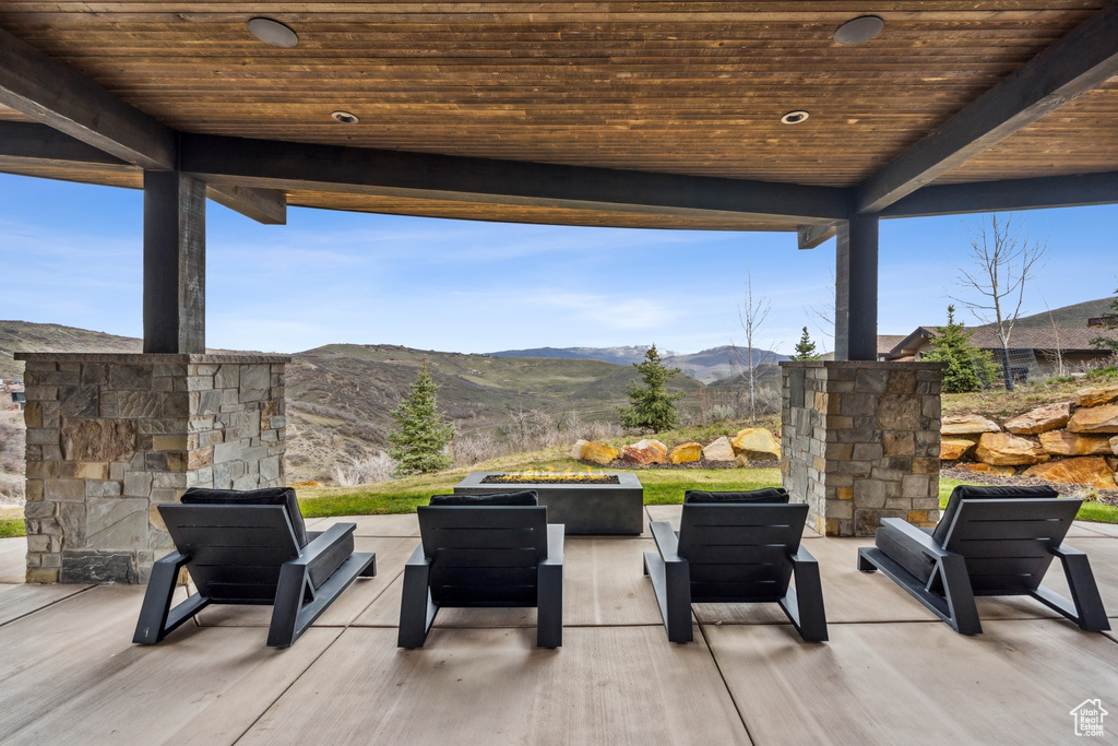 View of patio featuring a mountain view and an outdoor living space with a fire pit