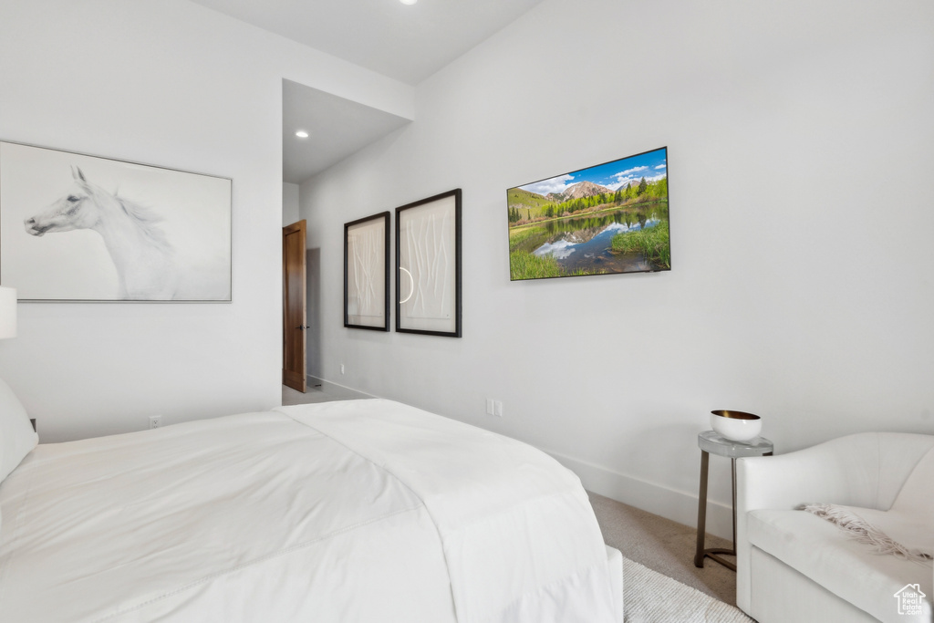 Bedroom with recessed lighting, light colored carpet, and baseboards