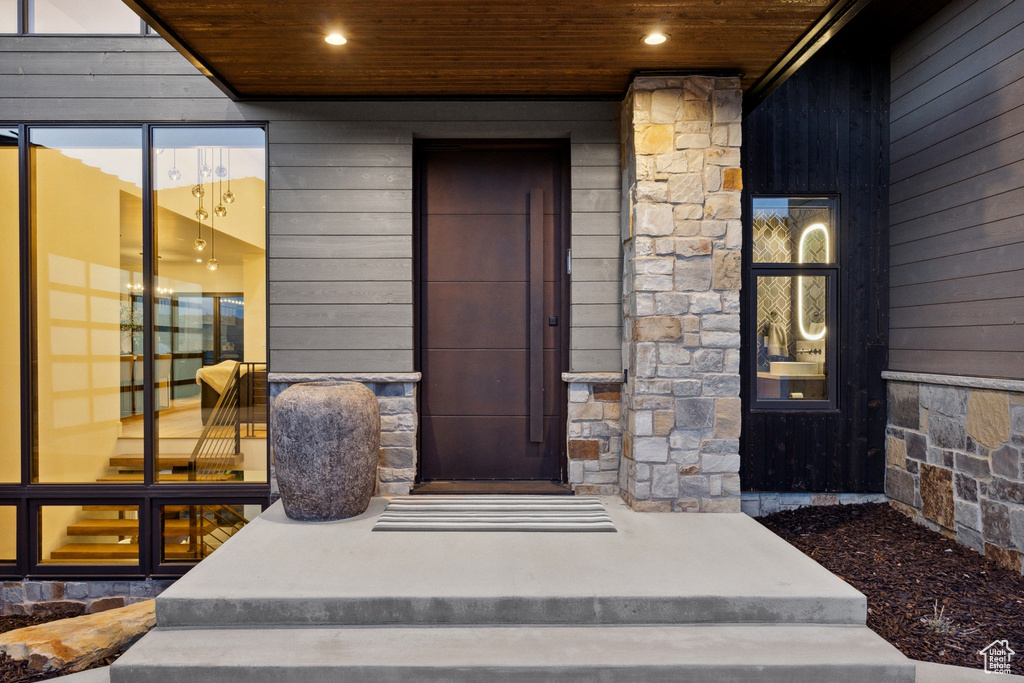 Entrance to property with stone siding