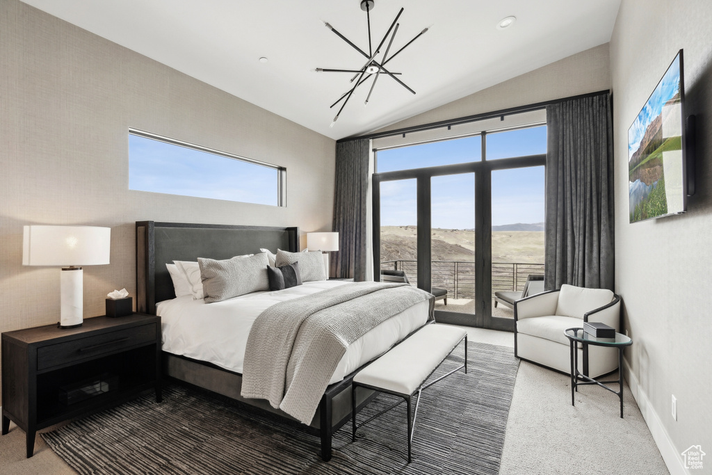 Bedroom with carpet flooring, a notable chandelier, access to outside, a mountain view, and lofted ceiling