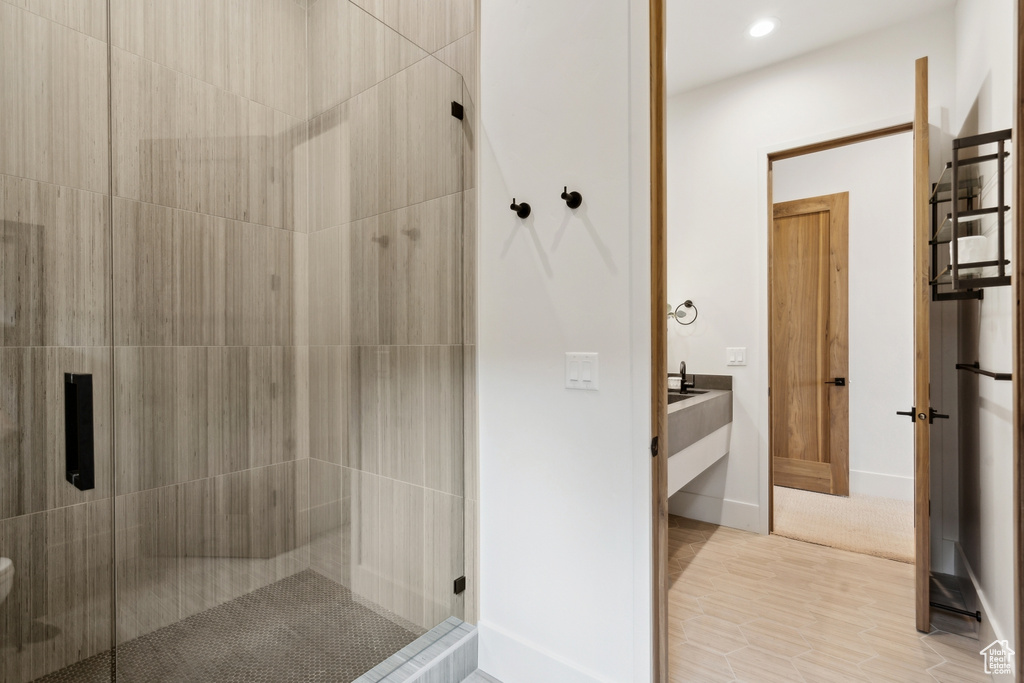 Bathroom featuring vanity, a shower stall, and recessed lighting