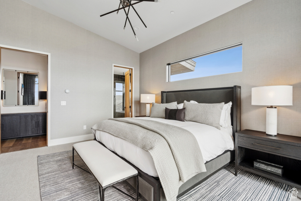 Bedroom with lofted ceiling, baseboards, carpet floors, and multiple windows