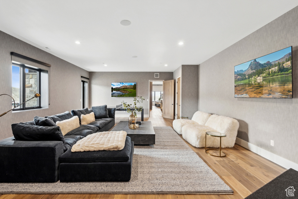 Living area featuring wood finished floors, recessed lighting, and baseboards