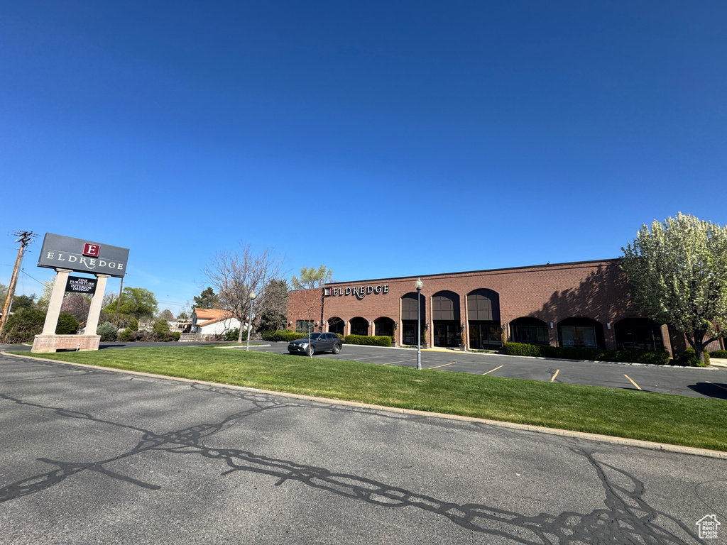 View of property featuring uncovered parking
