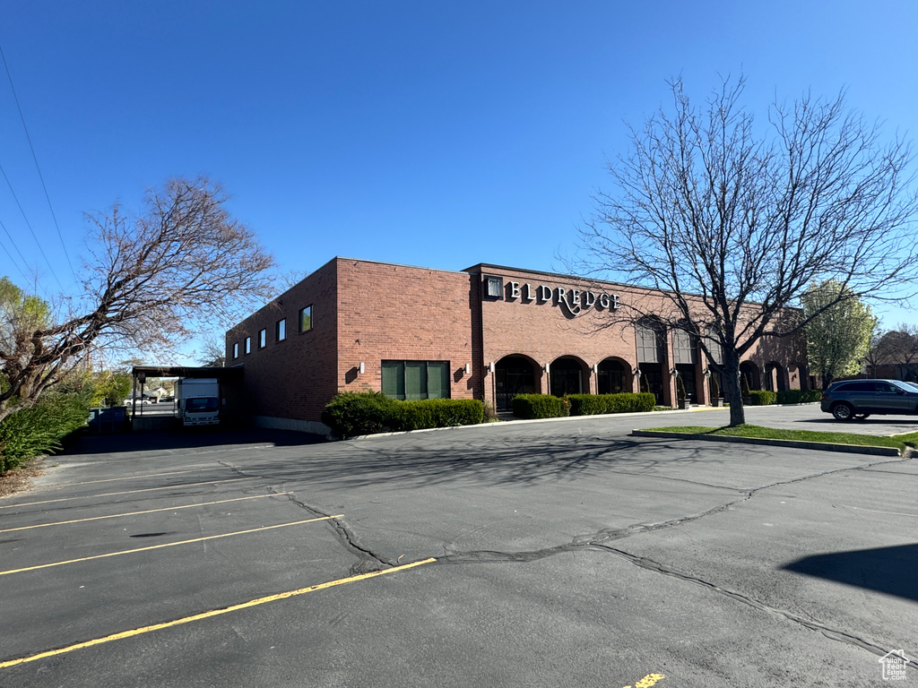 View of property with uncovered parking