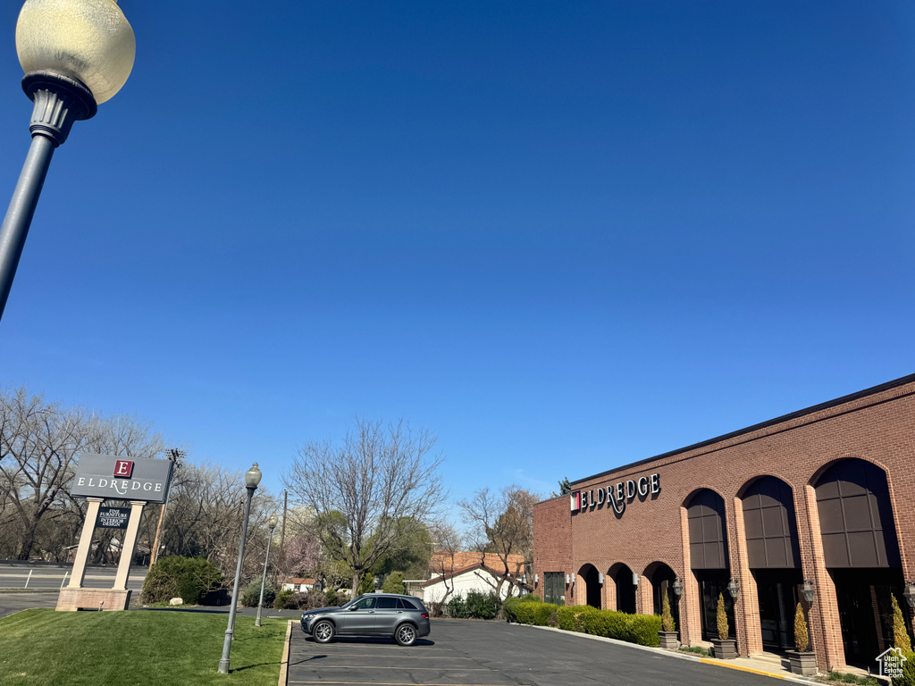 View of building exterior with uncovered parking