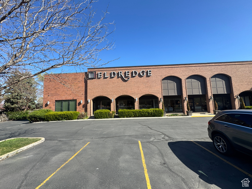 View of building exterior with uncovered parking