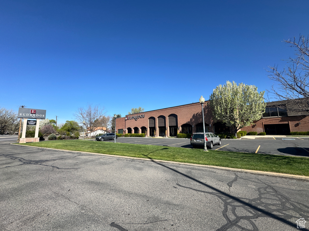 View of building exterior featuring uncovered parking