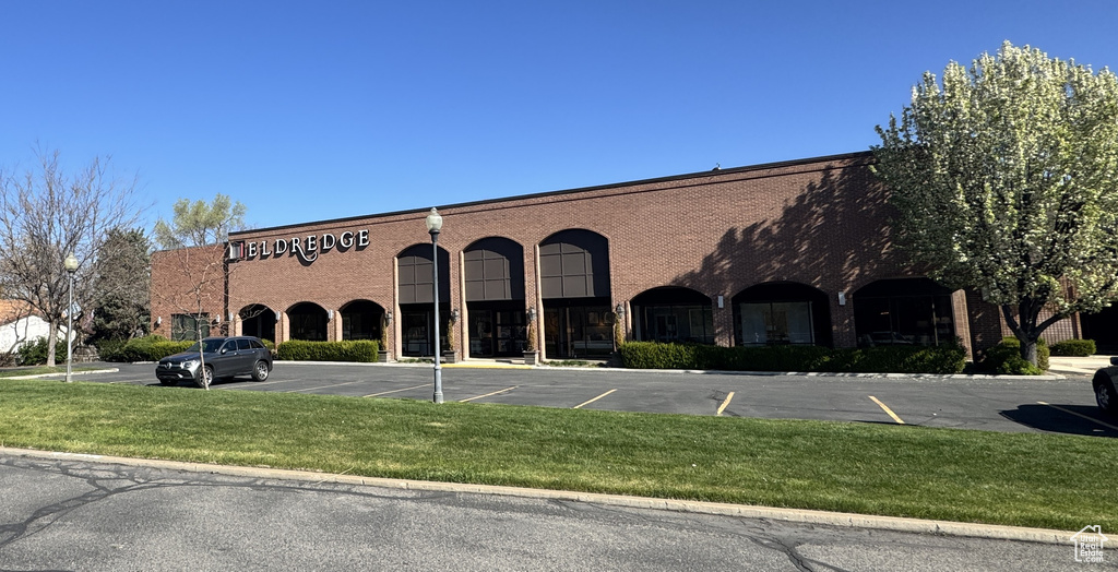View of building exterior with uncovered parking