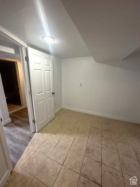 Interior space with baseboards and light tile patterned floors