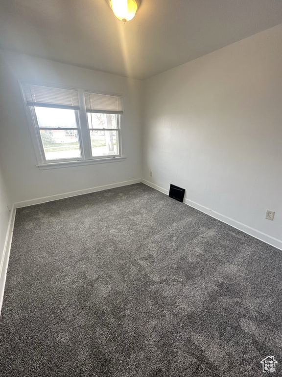 Carpeted empty room with baseboards