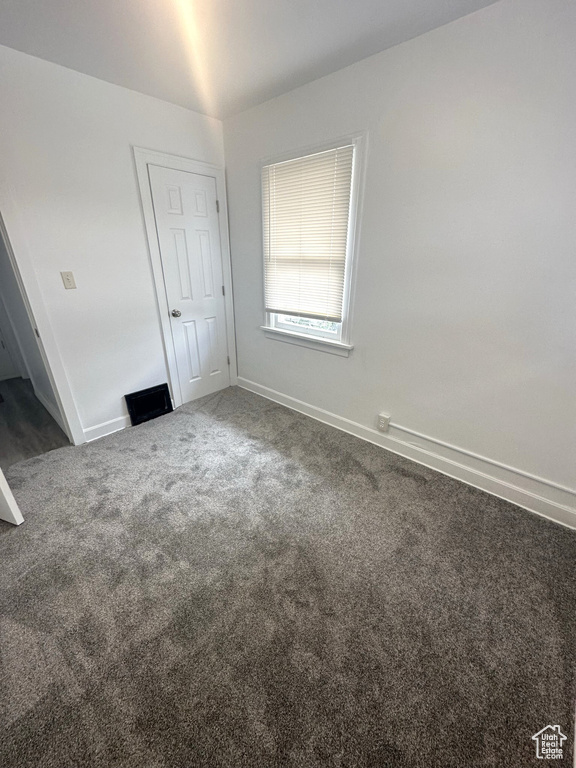 Unfurnished bedroom featuring carpet and baseboards