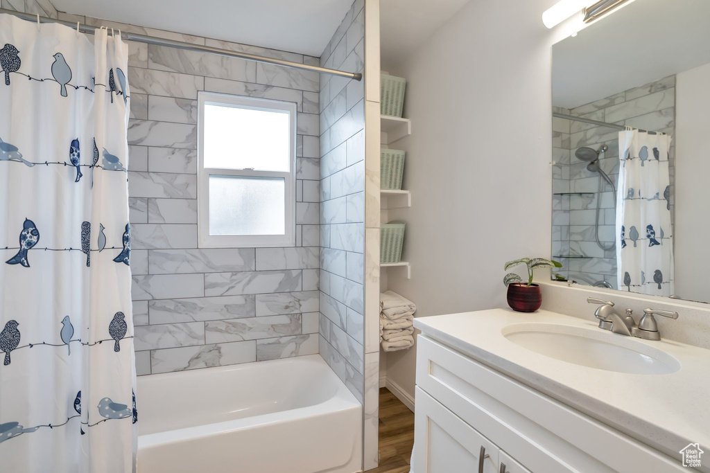 Full bath with shower / bathtub combination with curtain and vanity