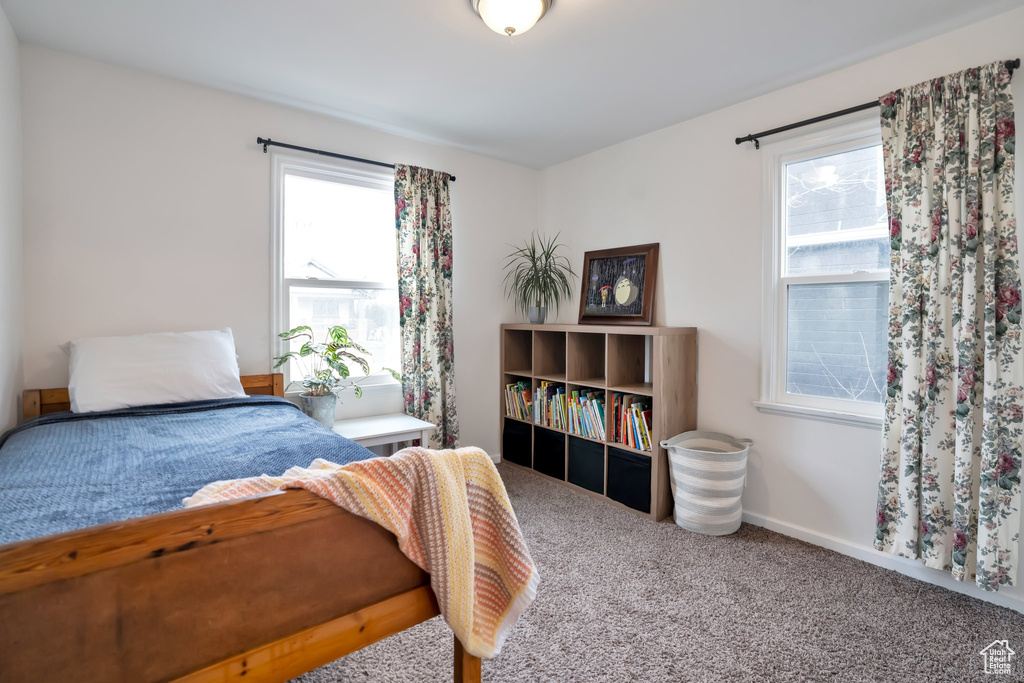 Carpeted bedroom featuring baseboards