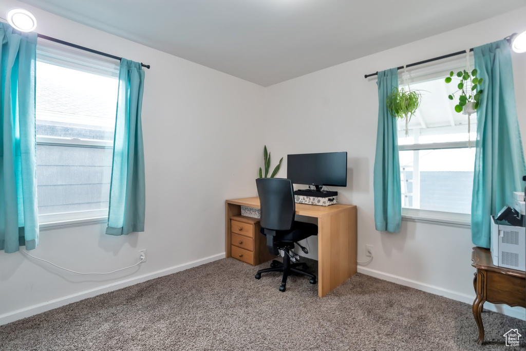 Home office with carpet flooring and baseboards
