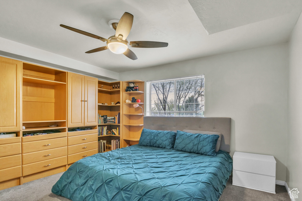 Bedroom featuring a ceiling fan and carpet flooring