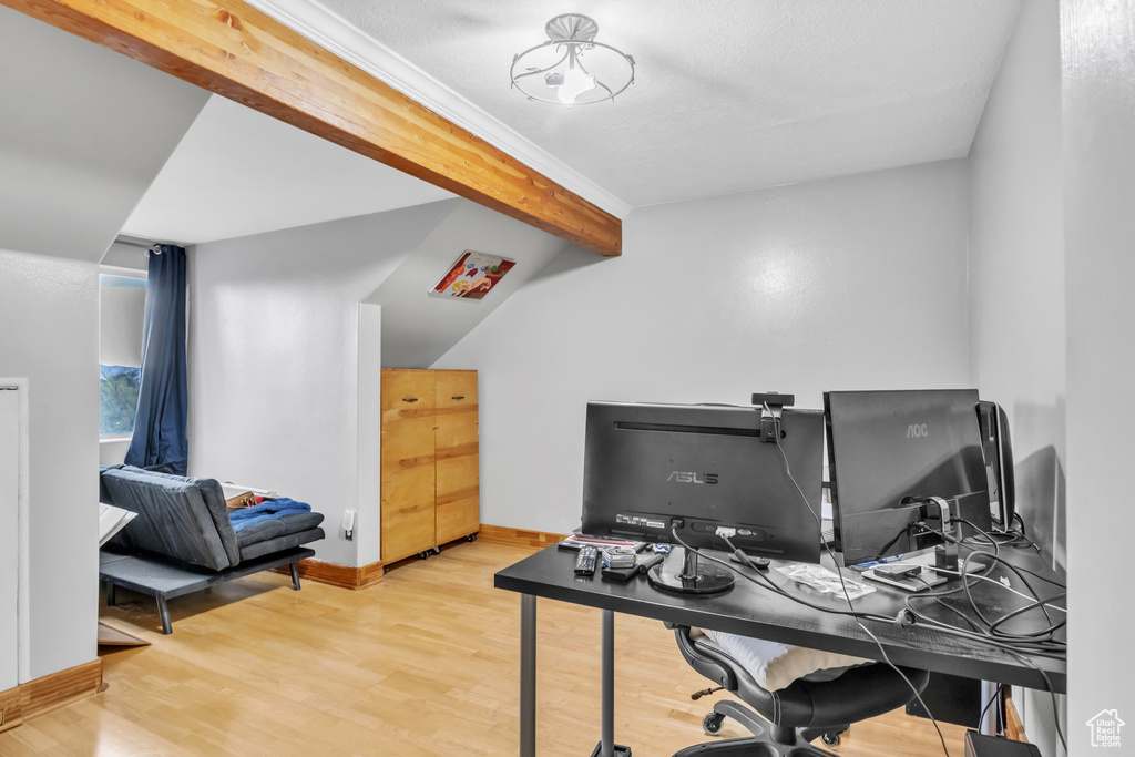 Home office with wood finished floors, vaulted ceiling with beams, and baseboards