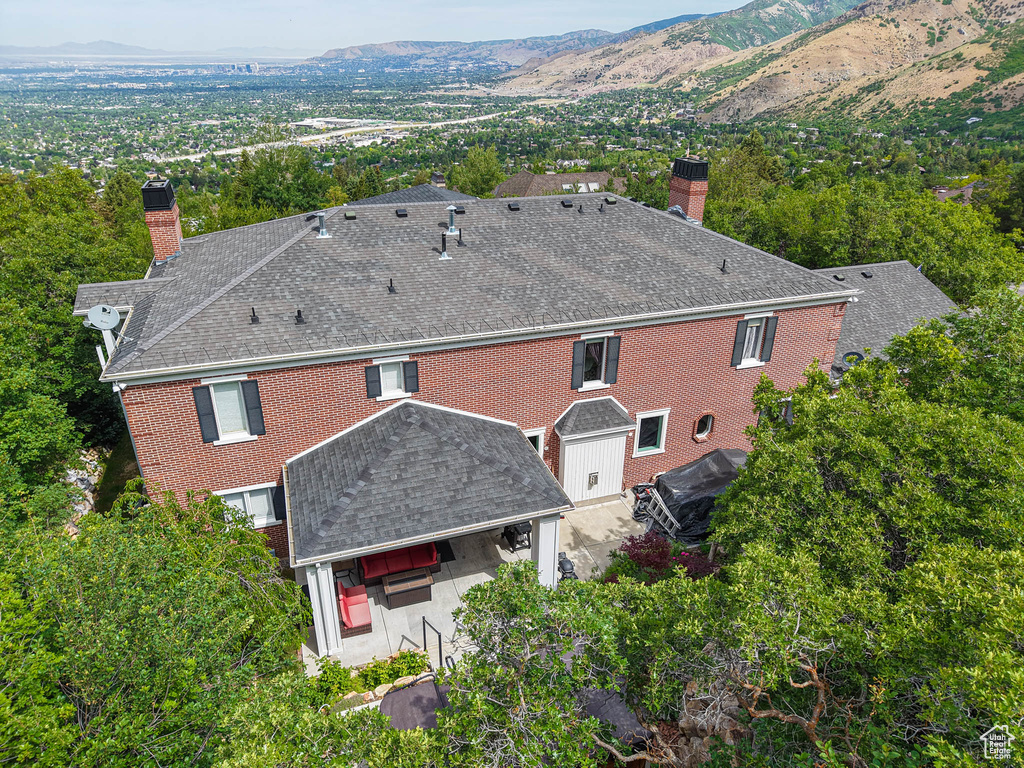 Aerial view of property and surrounding area with a mountainous background