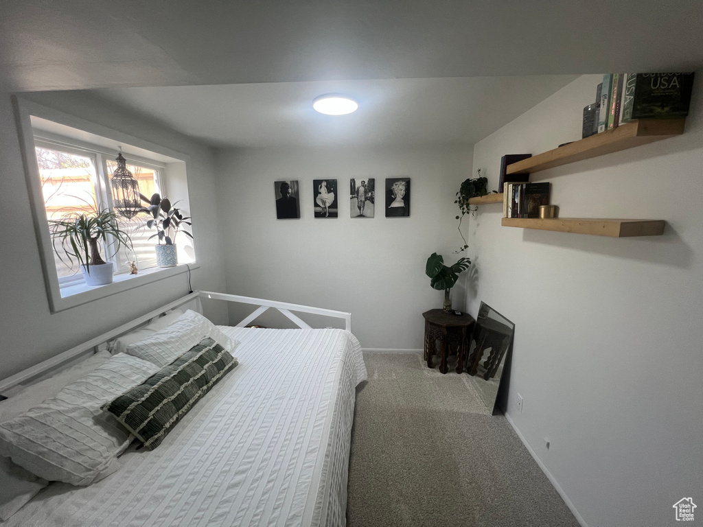 Bedroom featuring baseboards, a notable chandelier, and carpet flooring