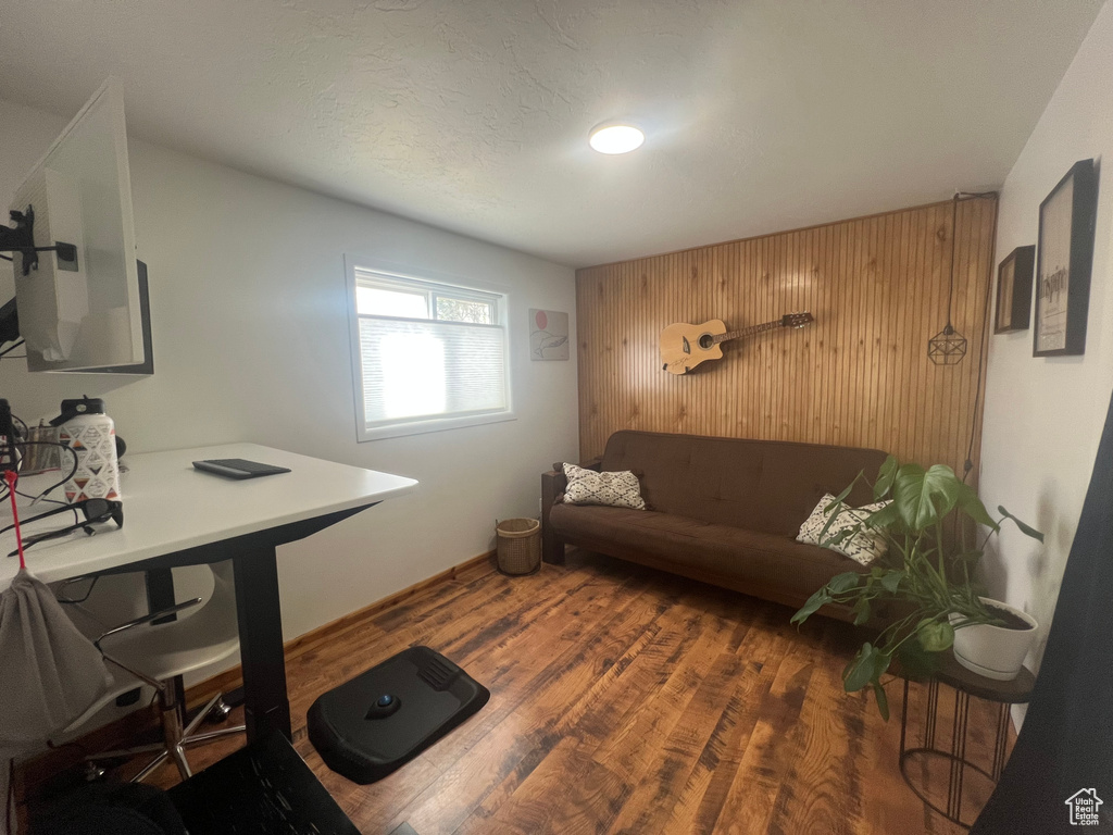 Office area with wood finished floors and wooden walls