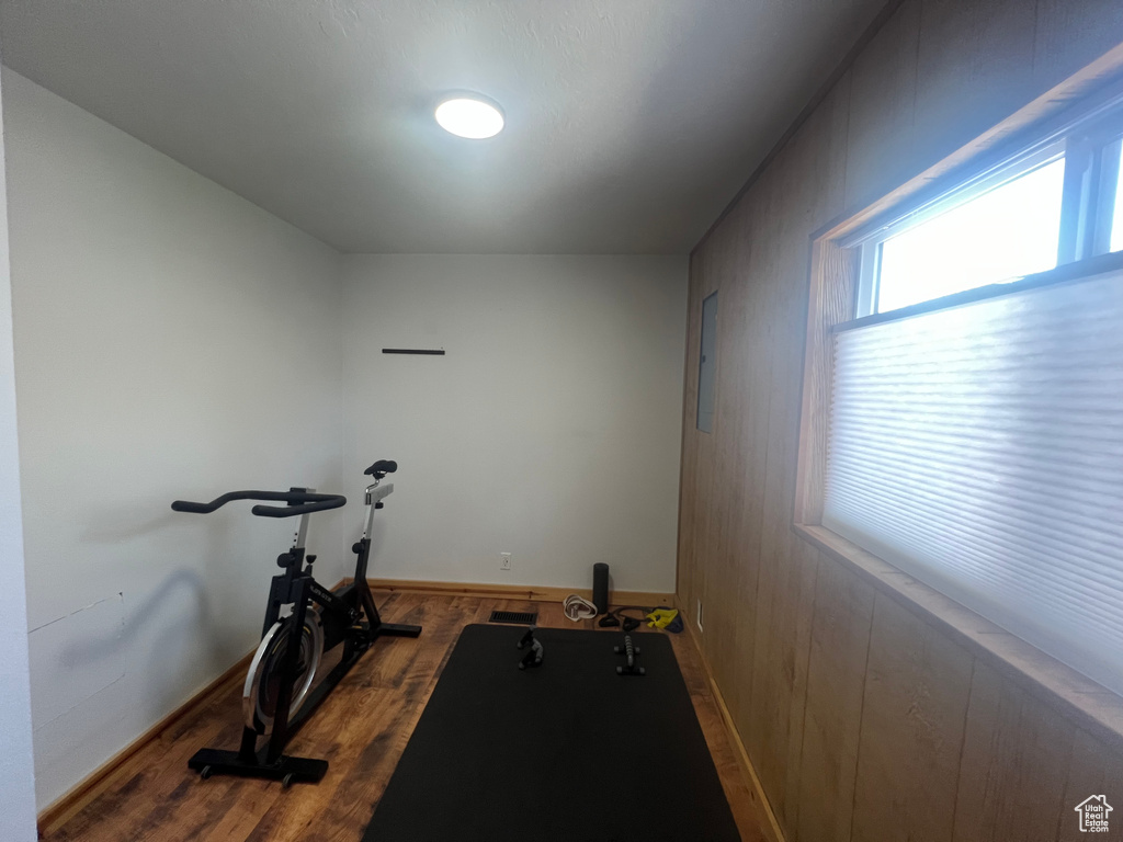 Exercise area with baseboards and dark wood-type flooring