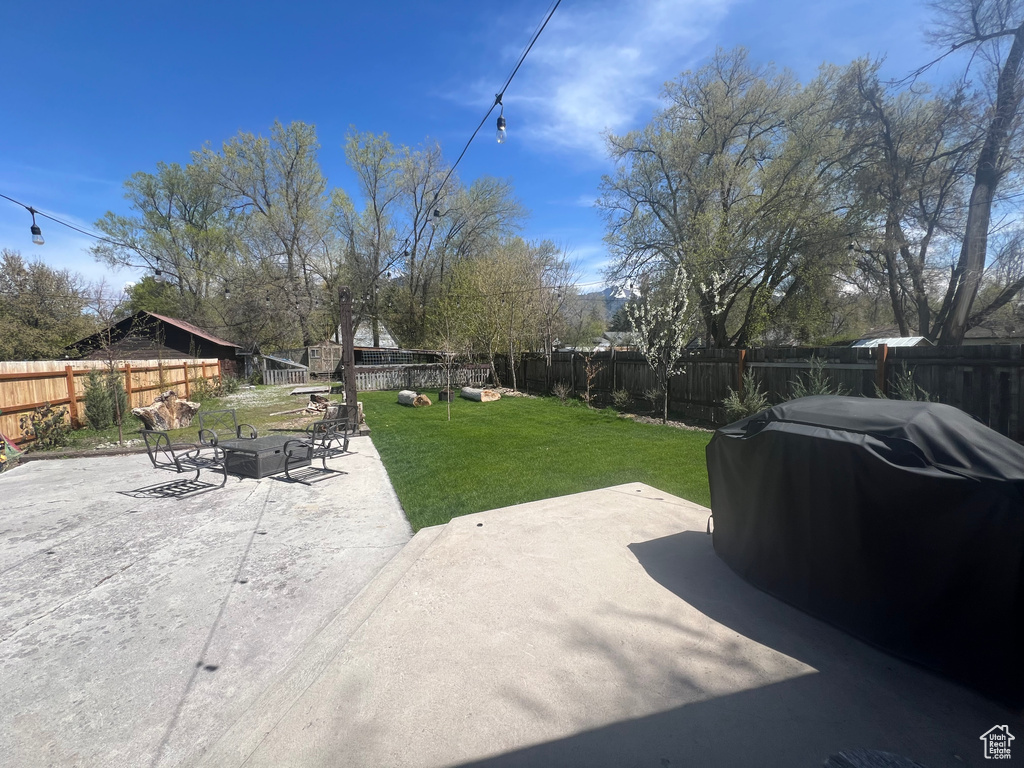 View of yard featuring a patio area and a fenced backyard