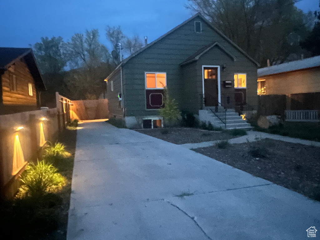 Bungalow-style house featuring fence and concrete driveway