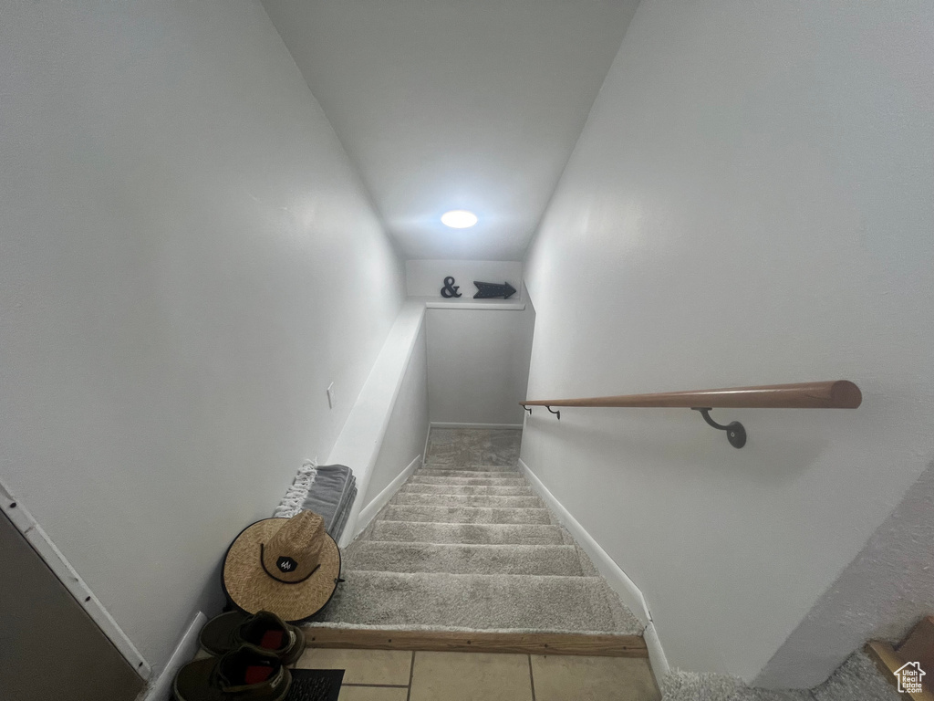 Staircase featuring carpet flooring and baseboards