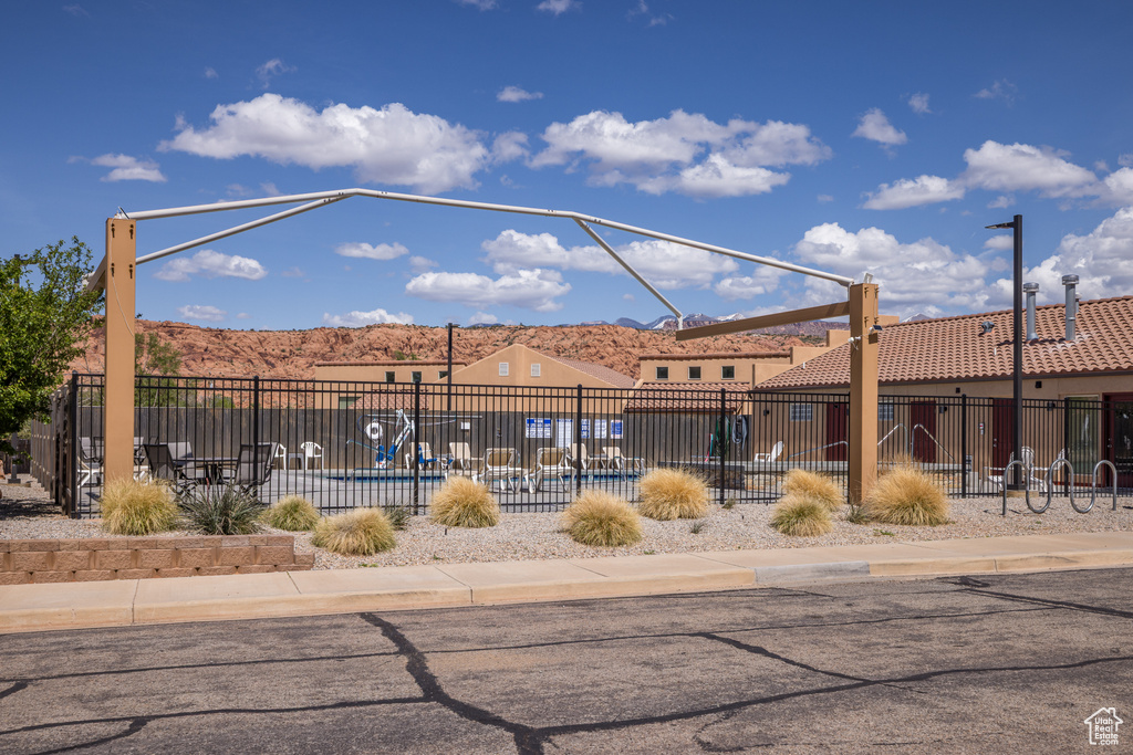 View of home\'s community with fence and a mountain view