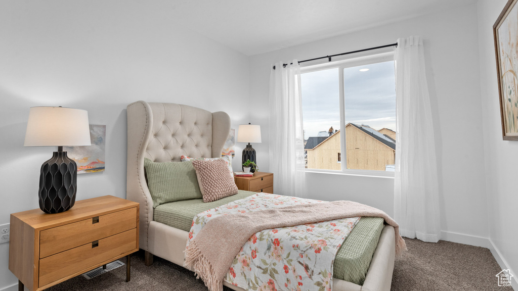 Bedroom featuring baseboards, visible vents, multiple windows, and carpet