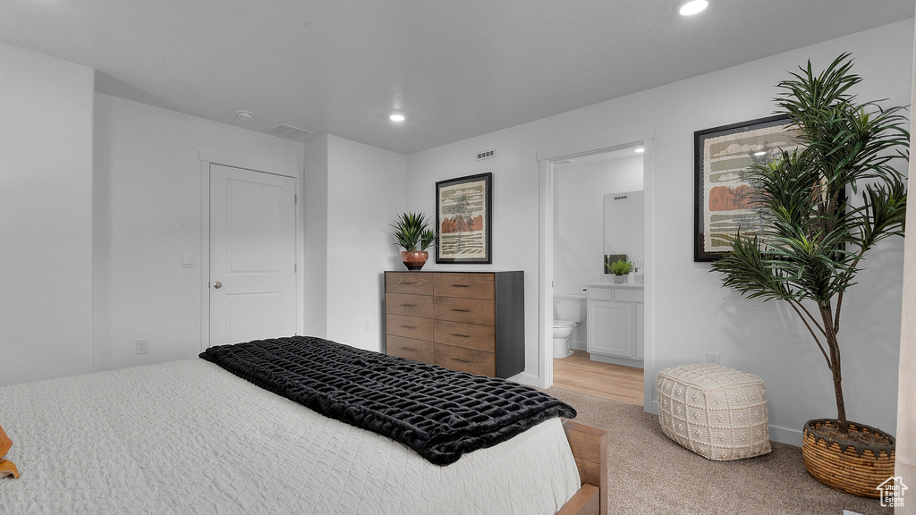 Bedroom featuring recessed lighting, visible vents, light colored carpet, and ensuite bathroom