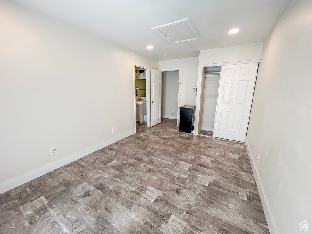Unfurnished bedroom featuring wood finished floors, recessed lighting, and baseboards