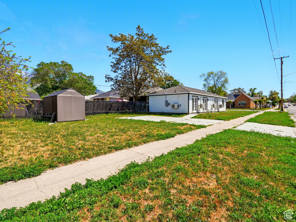 View of yard with a storage shed and an outdoor structure
