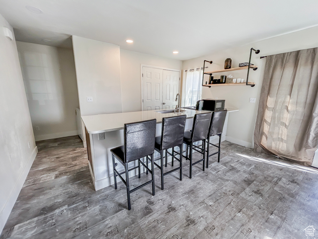 Interior space with wood finished floors, recessed lighting, and baseboards