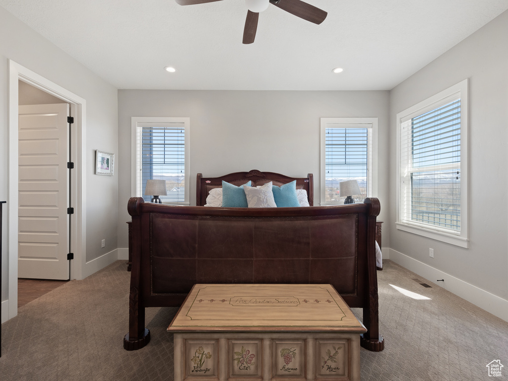 Bedroom with baseboards, multiple windows, and carpet flooring