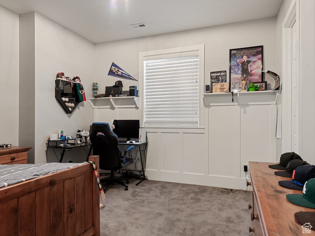 Bedroom with visible vents and light colored carpet