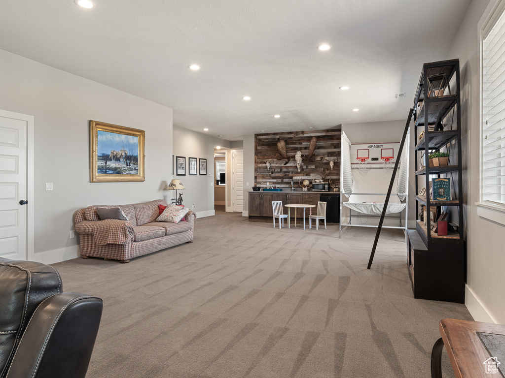 Carpeted living room with baseboards and recessed lighting