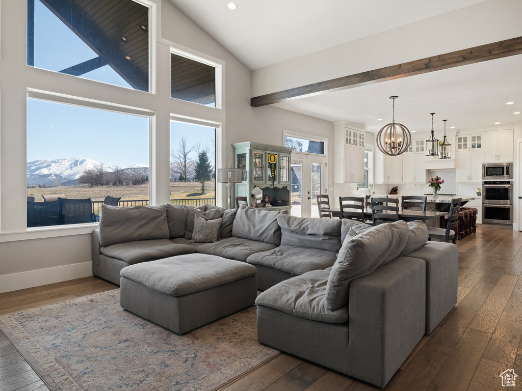 Living area featuring a mountain view, recessed lighting, a notable chandelier, and dark wood-type flooring