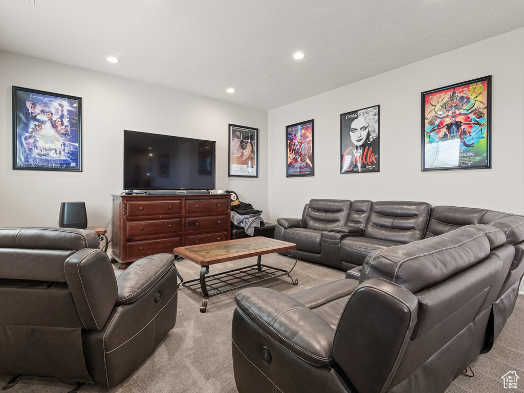 Living room with recessed lighting and light carpet