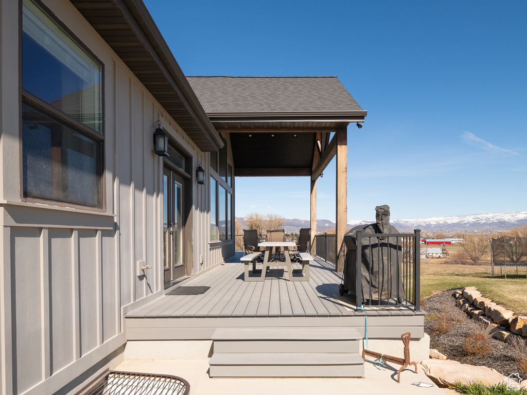 Deck with a mountain view and outdoor dining space