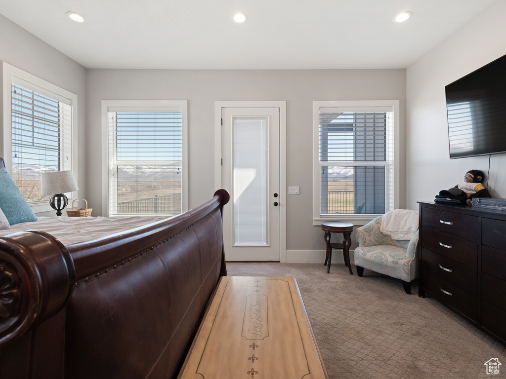 Bedroom featuring multiple windows, recessed lighting, baseboards, and light carpet