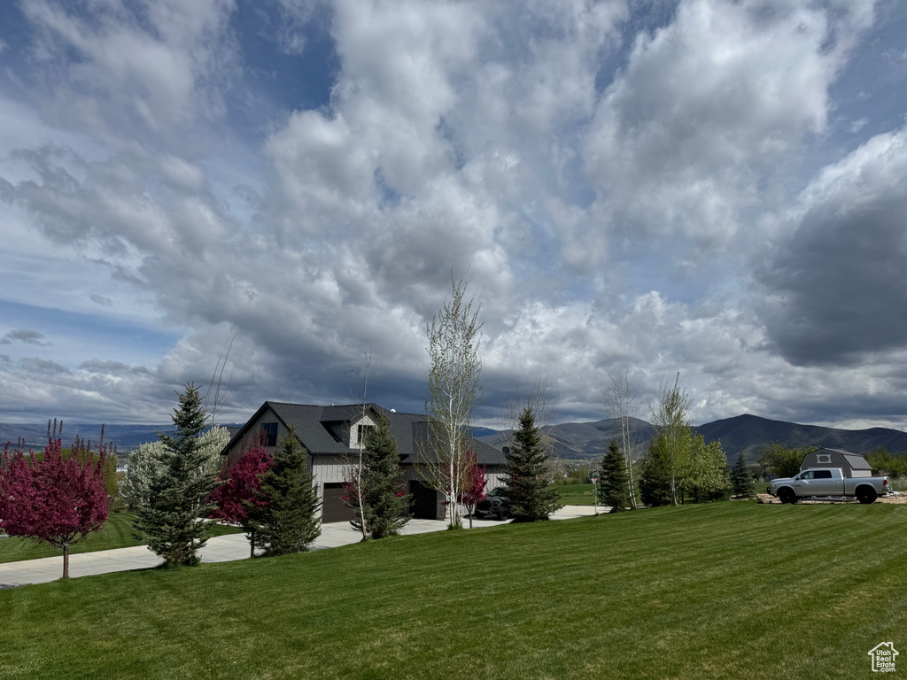 View of grassy yard with a mountain view