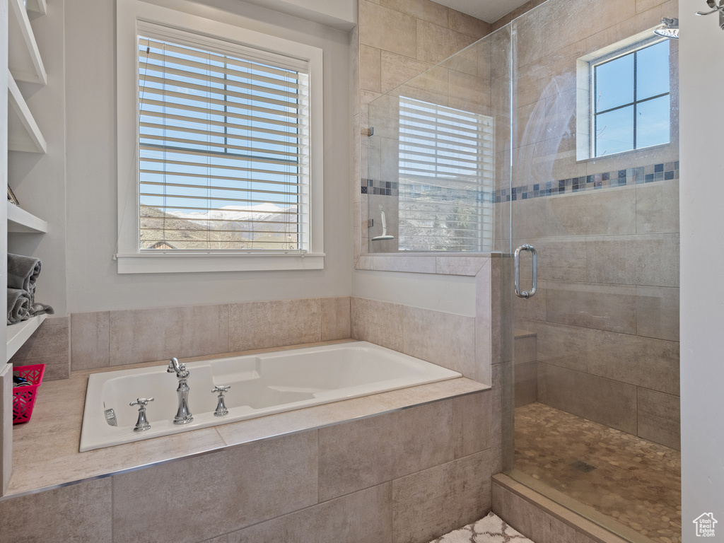 Full bath with a stall shower and a garden tub