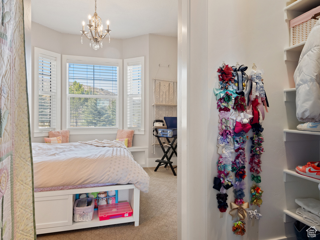 Bedroom featuring a notable chandelier and carpet floors