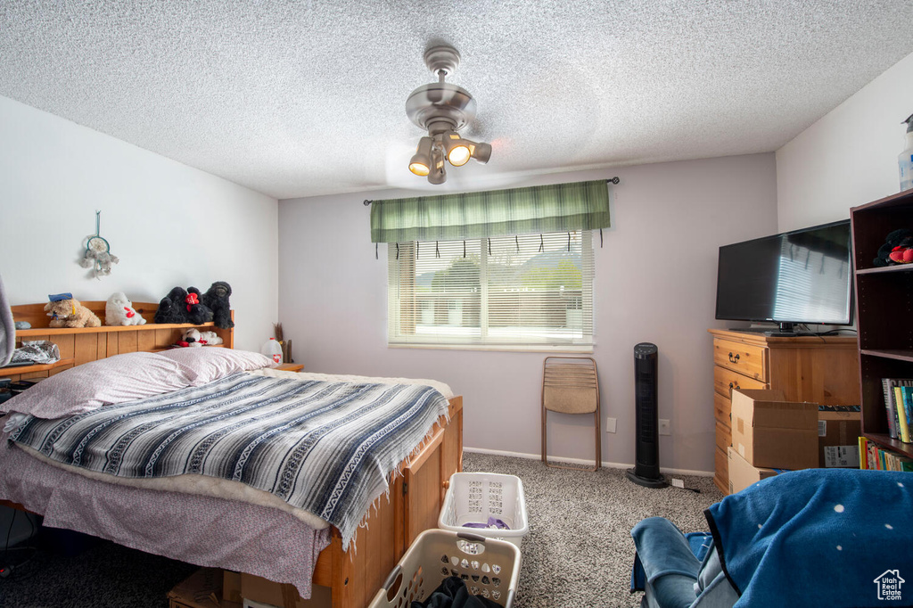 Carpeted bedroom featuring a textured ceiling