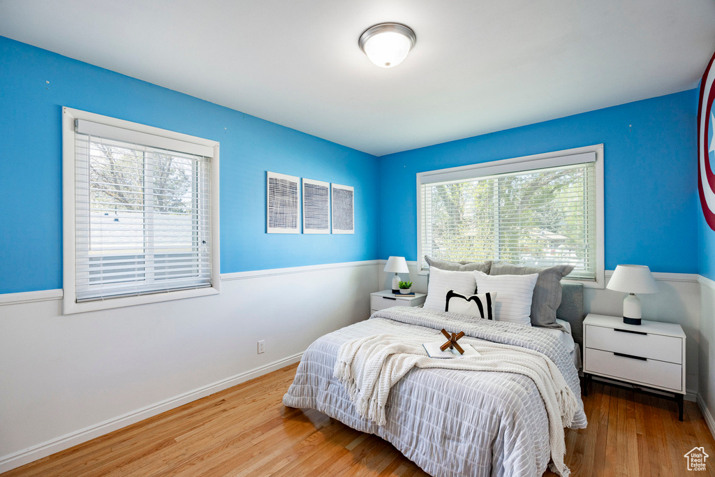 Bedroom featuring wood finished floors and baseboards