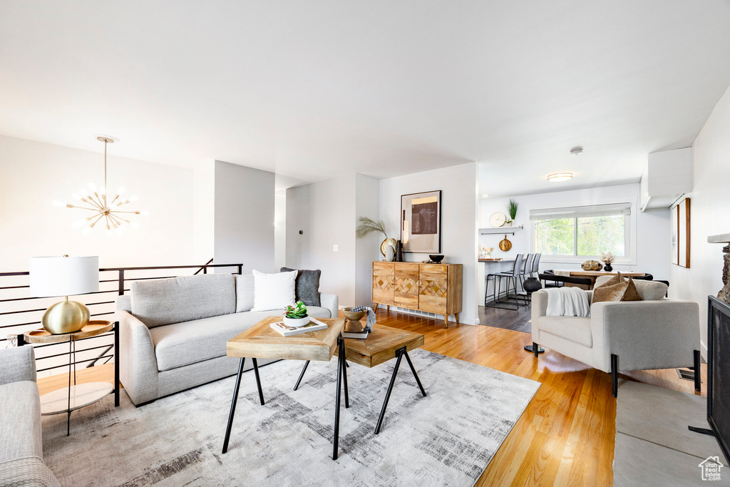 Living area featuring a notable chandelier and light wood-style floors