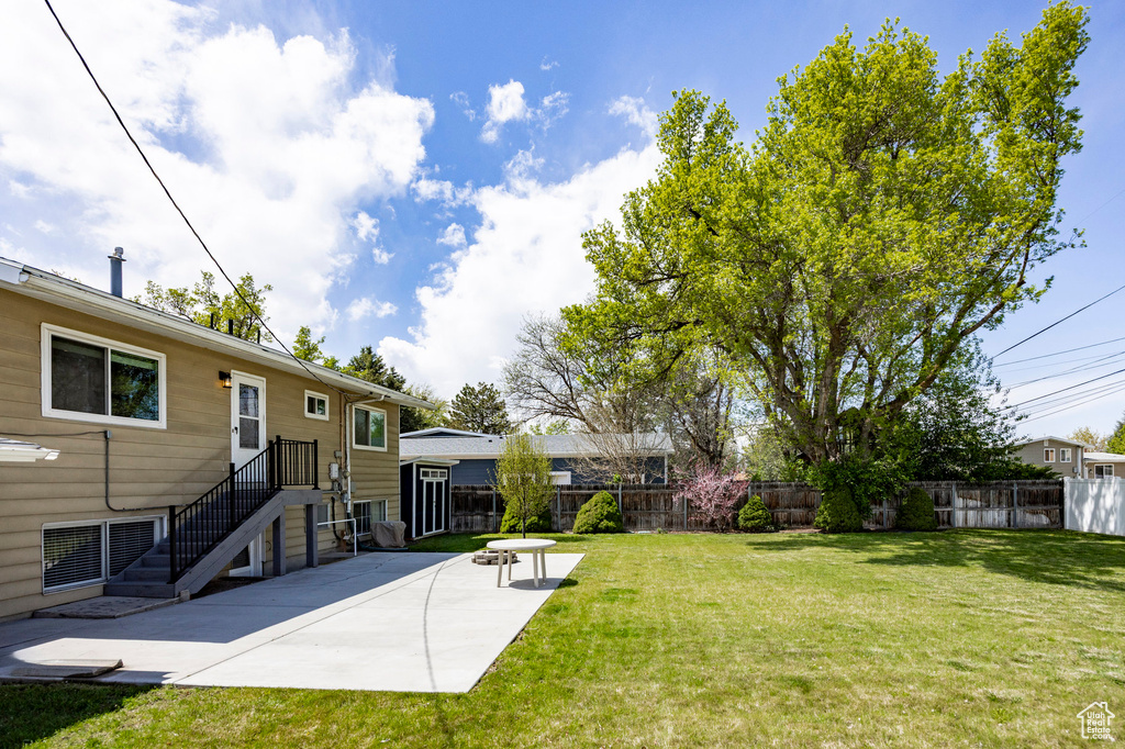 View of yard featuring fence and a patio area