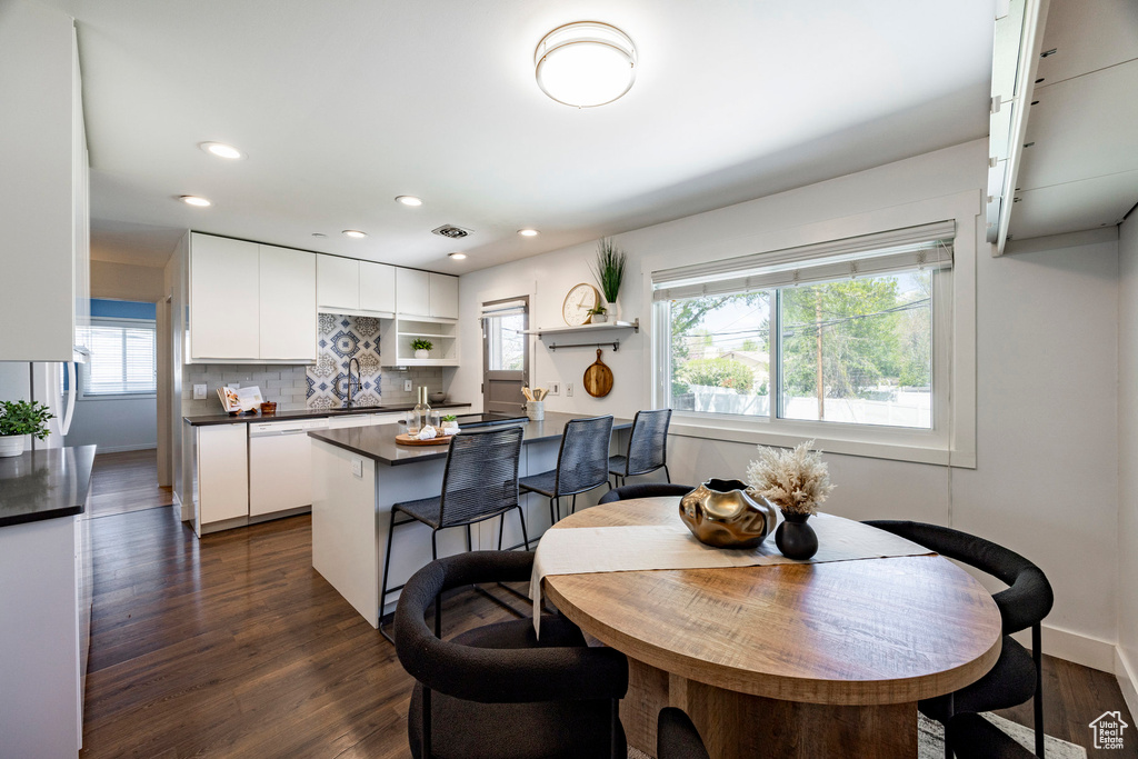 Dining room featuring recessed lighting, baseboards, and dark wood-type flooring